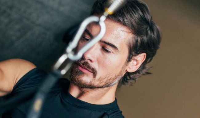 a man with a beard working out