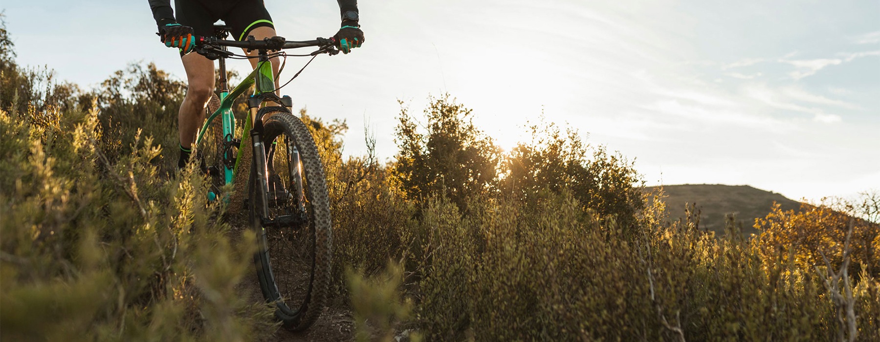 a person biking down a grassy hillside